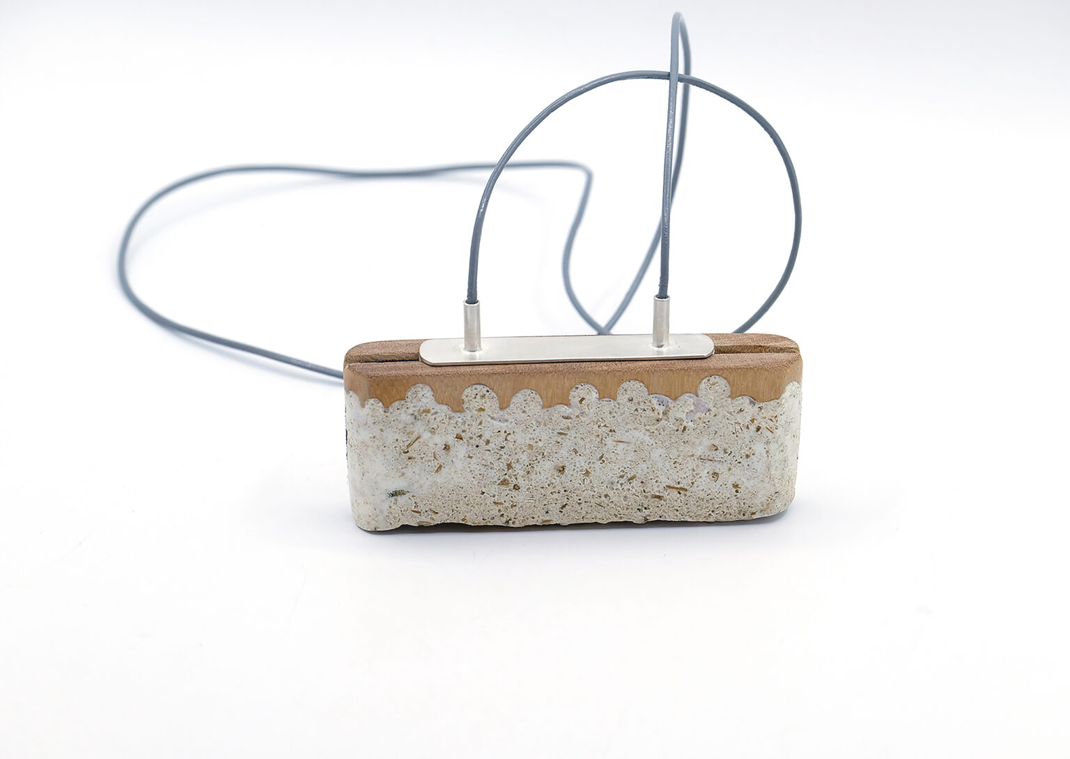 Pendant. wood, silver, reconstructed prickly-pear fibres, leather cord, elastic band. Photo by artists